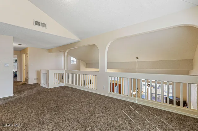 a view of a workspace with furniture and a flat screen tv