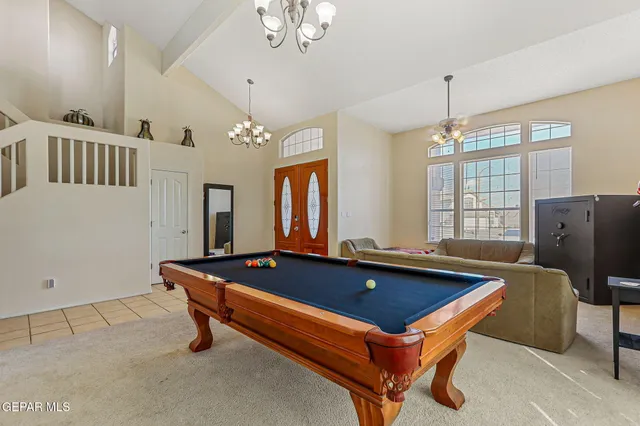 a living room with furniture and a chandelier