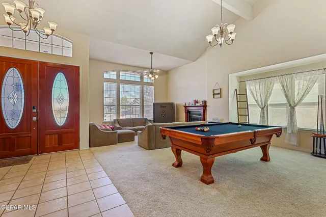 a room with a table and a chandelier