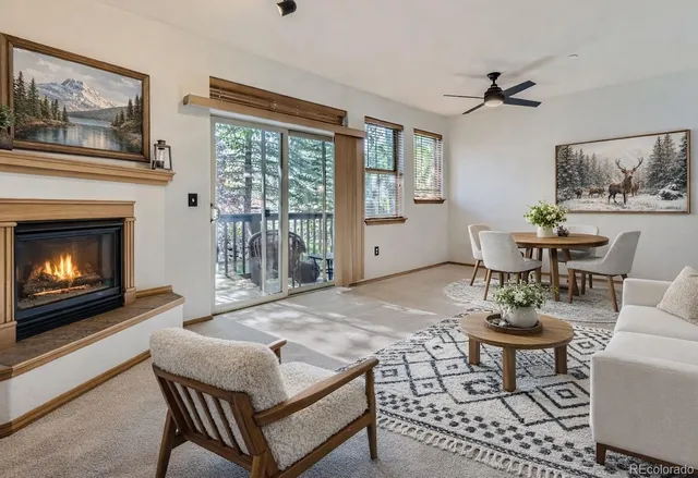 a living room with furniture a table and a fireplace