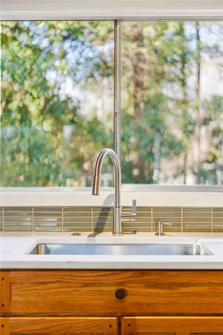 a large kitchen with stainless steel appliances granite countertop a stove and a sink