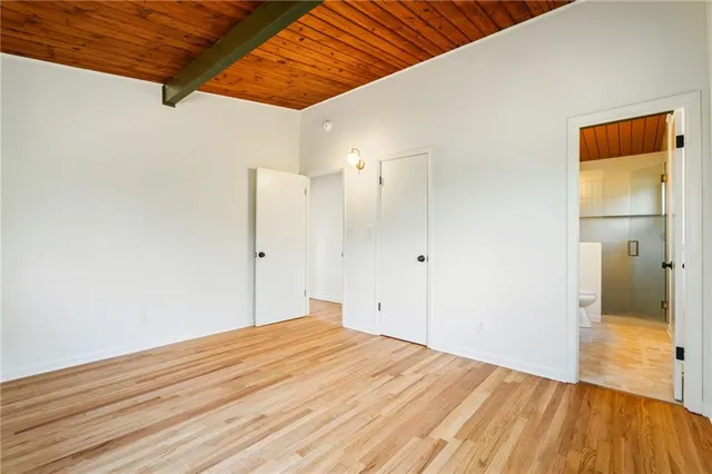 a bathroom with a double vanity sink toilet and a mirror