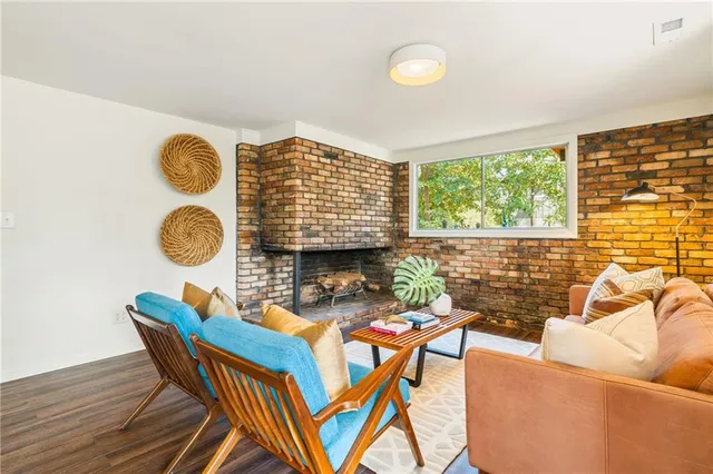 a living room with furniture and a floor to ceiling window