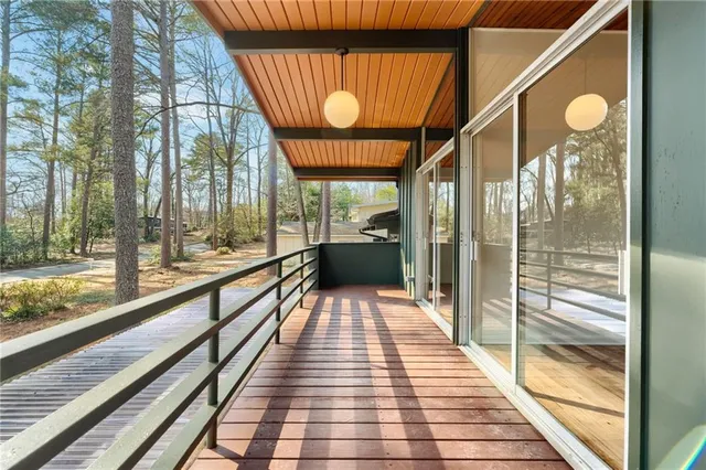 a view of a patio with table and chairs and wooden floor