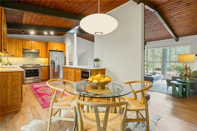 a dining room with furniture and a floor to ceiling window