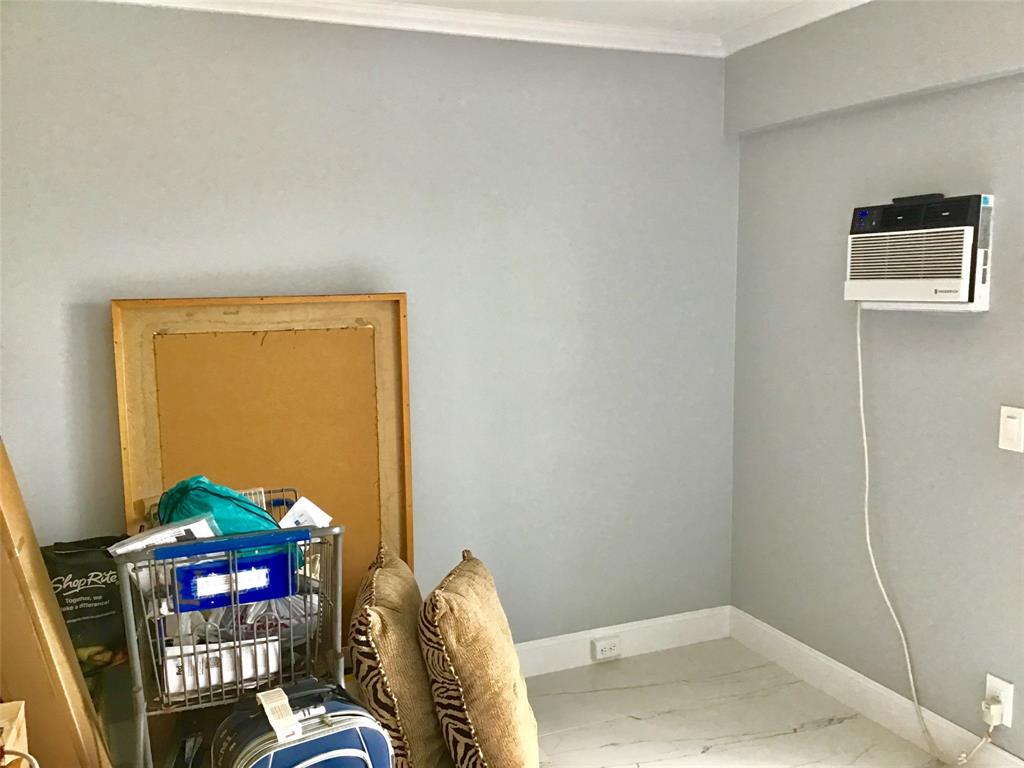 35 Suffolk Way, Unit 35 Boca Raton, FL 33434 - Photo 12 of 20 a bedroom with a bed and a chair