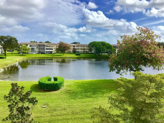 a view of a lake with houses in the back