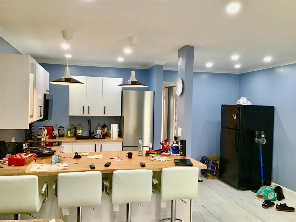 35 Suffolk Way, Unit 35 Boca Raton, FL 33434 - Photo 4 of 20 a kitchen with a sink a refrigerator and chairs