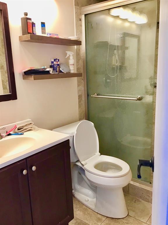 35 Suffolk Way, Unit 35 Boca Raton, FL 33434 - Photo 10 of 20 a bathroom with a toilet a sink and mirror