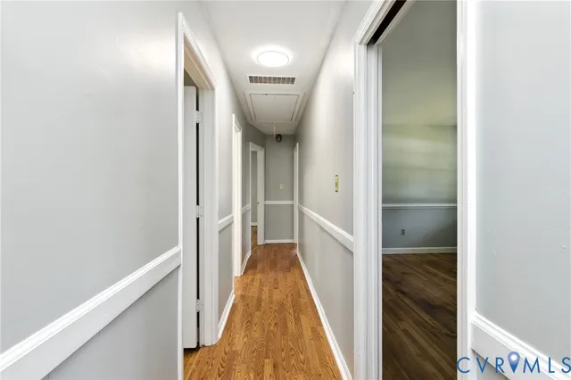 a view of hallway with wooden floor