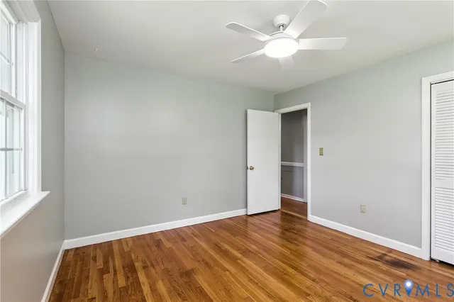 wooden floor in an empty room with a window