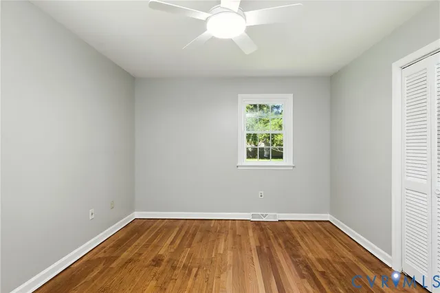 wooden floor in an empty room with a window