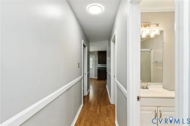 a view of hallway with wooden floor