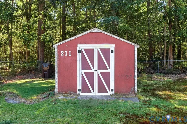 a view of backyard with deck and a garden