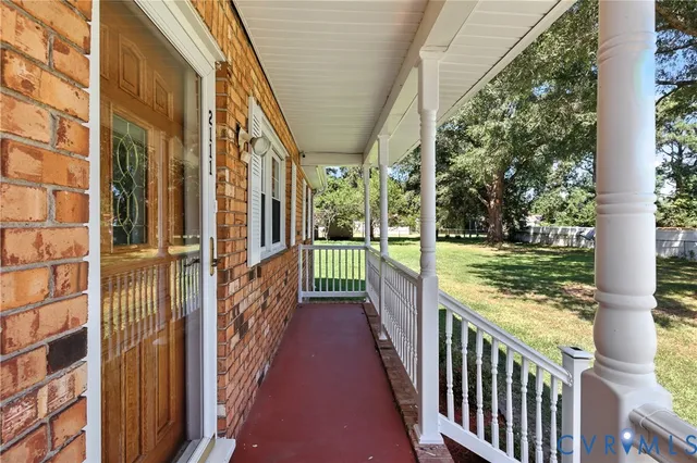 a view of a porch with wooden floor and fence