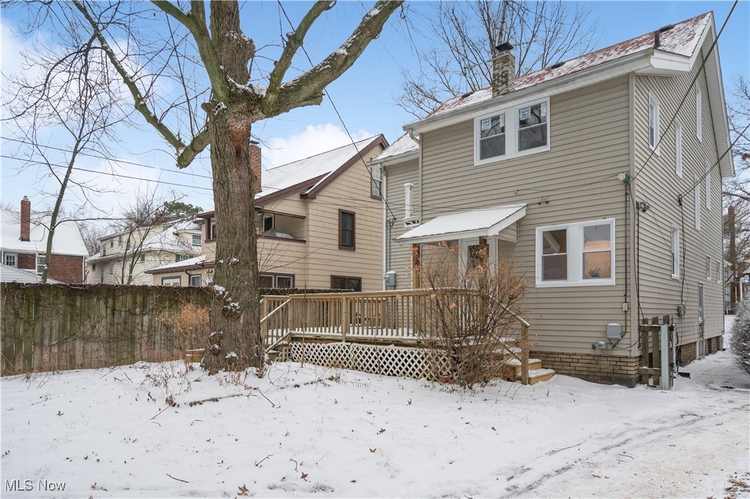 2016 Rossmoor Road Cleveland Heights, OH 44118 - Photo 46 of 46 Snow covered rear of property with a wooden deck and a chimney