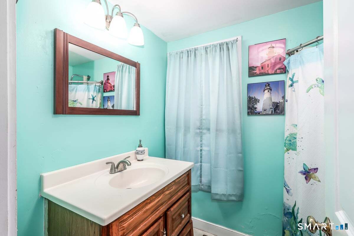 70 Dodgingtown Road Bethel, CT 06801 - Photo 20 of 27 a bathroom with a sink and a mirror