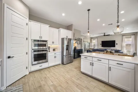 a kitchen with stainless steel appliances a stove refrigerator and microwave