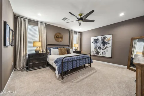 a bedroom with a large bed and a chandelier