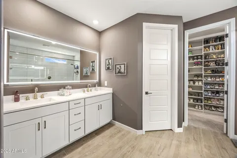 a bathroom with a double vanity sink and mirror