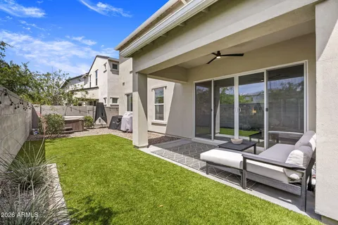 a view of a patio with table and chairs with wooden floor and fence