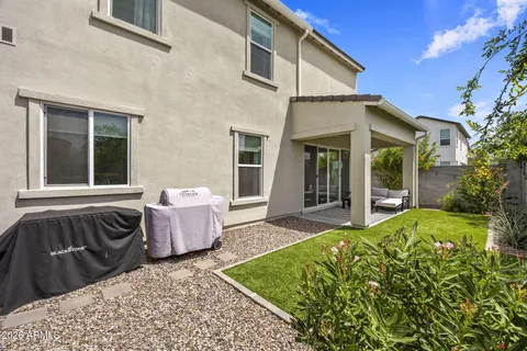 a view of a house with backyard and sitting area