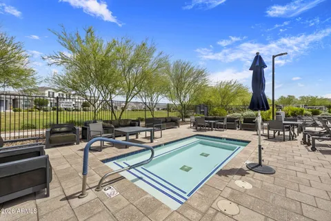 a view of a swimming pool with chairs in patio