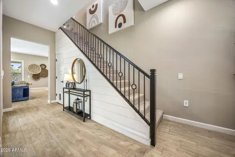 a view of entryway and hall with wooden floor