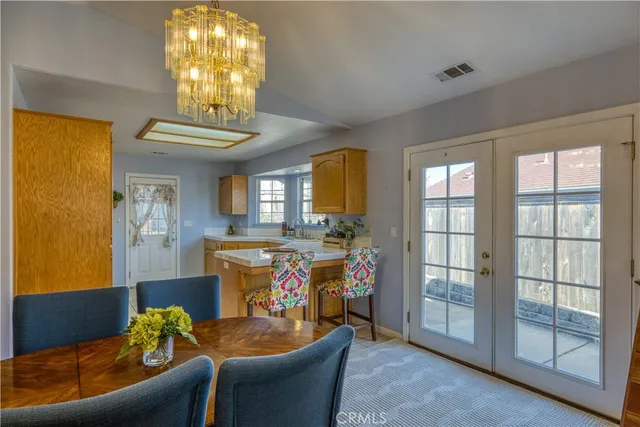 a living room with a couch and a chandelier