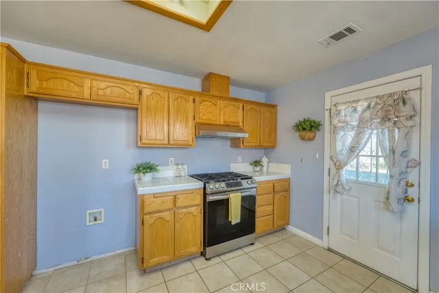 a kitchen with a stove top oven cabinets and a refrigerator
