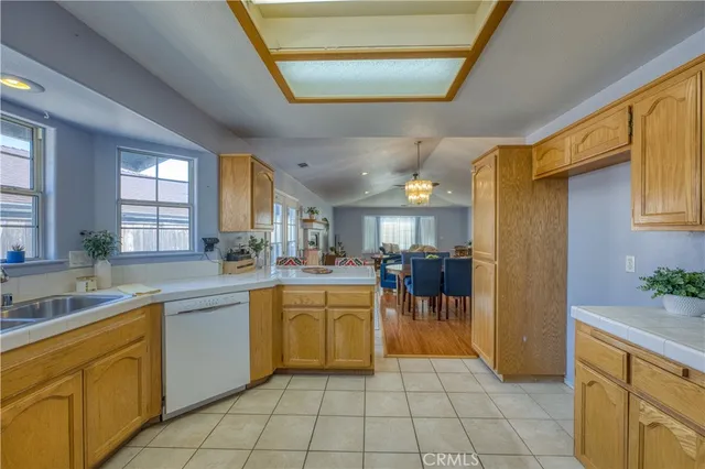 a kitchen with cabinets and chairs