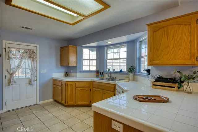 a kitchen with furniture a window and a sink