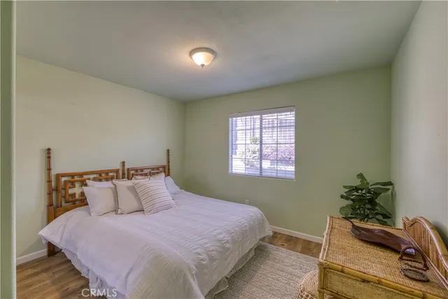 a bedroom with a bed and a potted plant