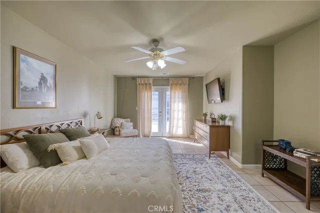 a bedroom with a bed and ceiling fan