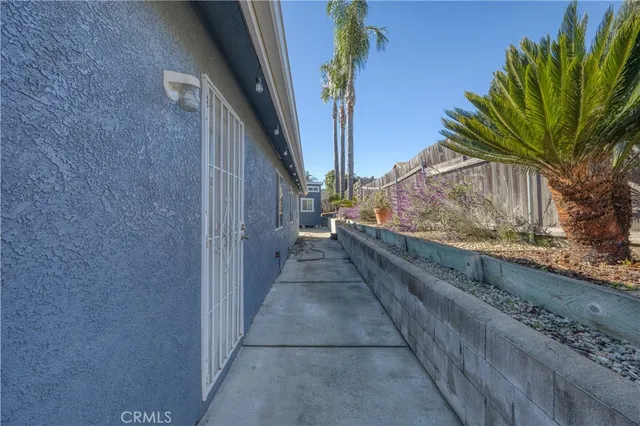a view of backyard with wooden fence and trees