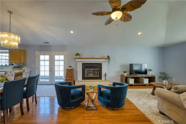 a living room with furniture a fireplace and a chandelier
