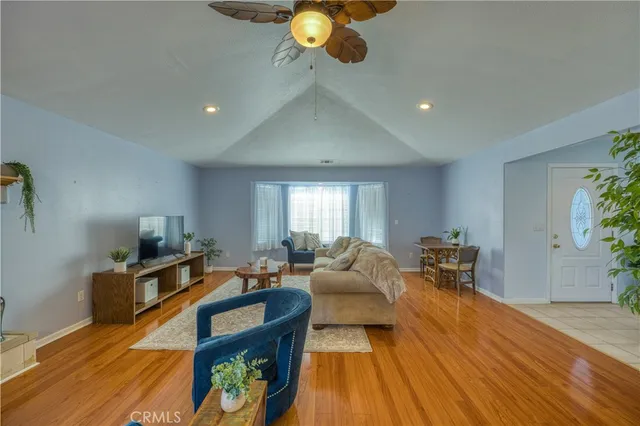 a living room with furniture and a wooden floor
