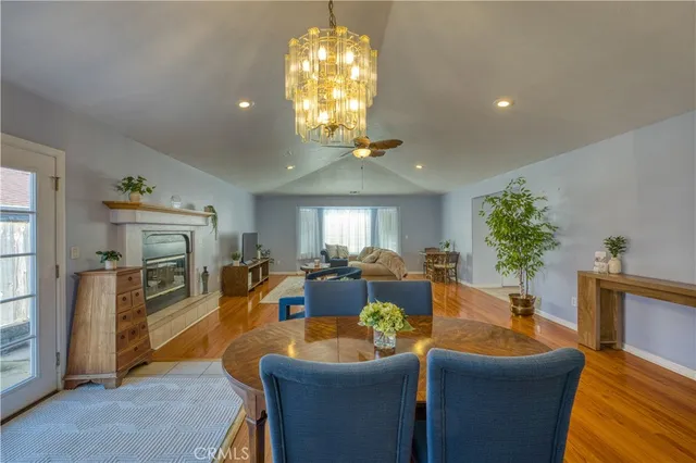 a living room with fireplace furniture and a chandelier