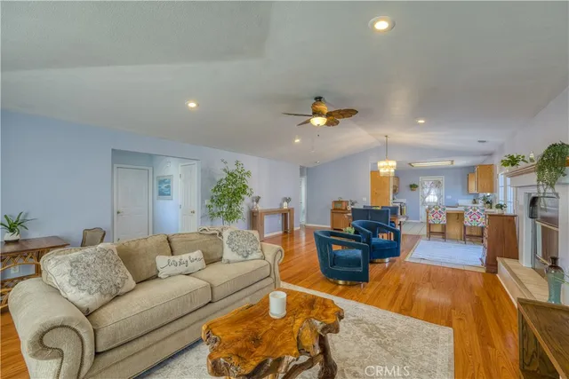 a living room with furniture and kitchen view
