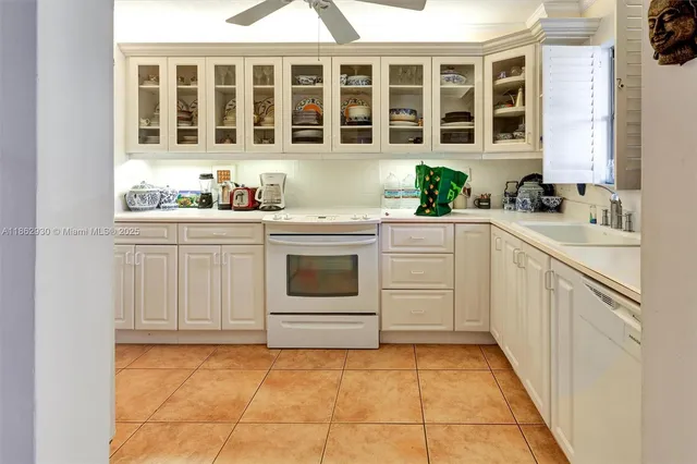 a kitchen with a stove sink and cabinets