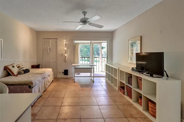 a bedroom with furniture and a flat screen tv