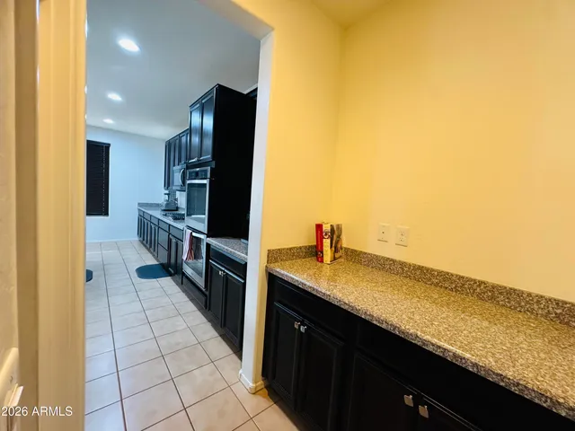 a kitchen with stainless steel appliances granite countertop a sink and cabinets