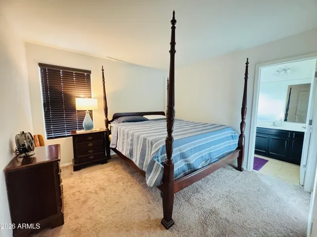 a bedroom with a bed and a dresser