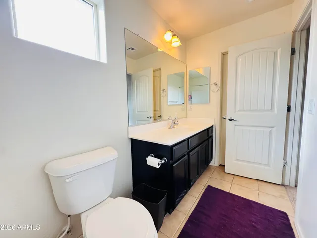 a bathroom with a sink vanity mirror and toilet