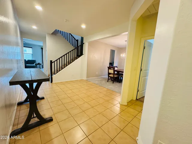a view of a hallway with wooden floor and chairs