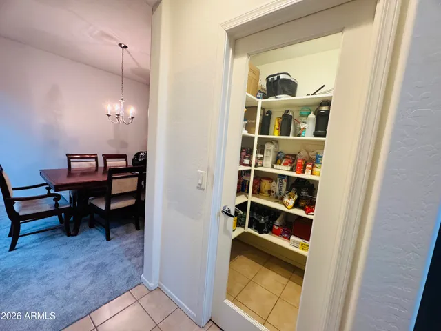 a view of a room that has a bed and a bookshelf in it