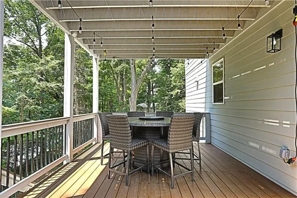 a view of a chairs and table in the balcony