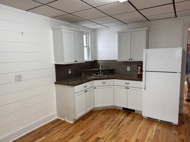43 West Church Street, Unit 100 Sandwich, IL 60548 - Photo 11 of 22 a view of a refrigerator in kitchen and wooden floor