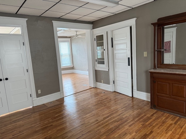 43 West Church Street, Unit 100 Sandwich, IL 60548 - Photo 14 of 22 an empty room with wooden floor and cabinet