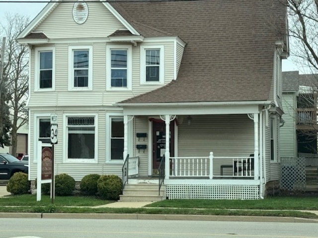 43 West Church Street, Unit 100 Sandwich, IL 60548 - Photo 20 of 22 a view of a brick house with a yard and large trees